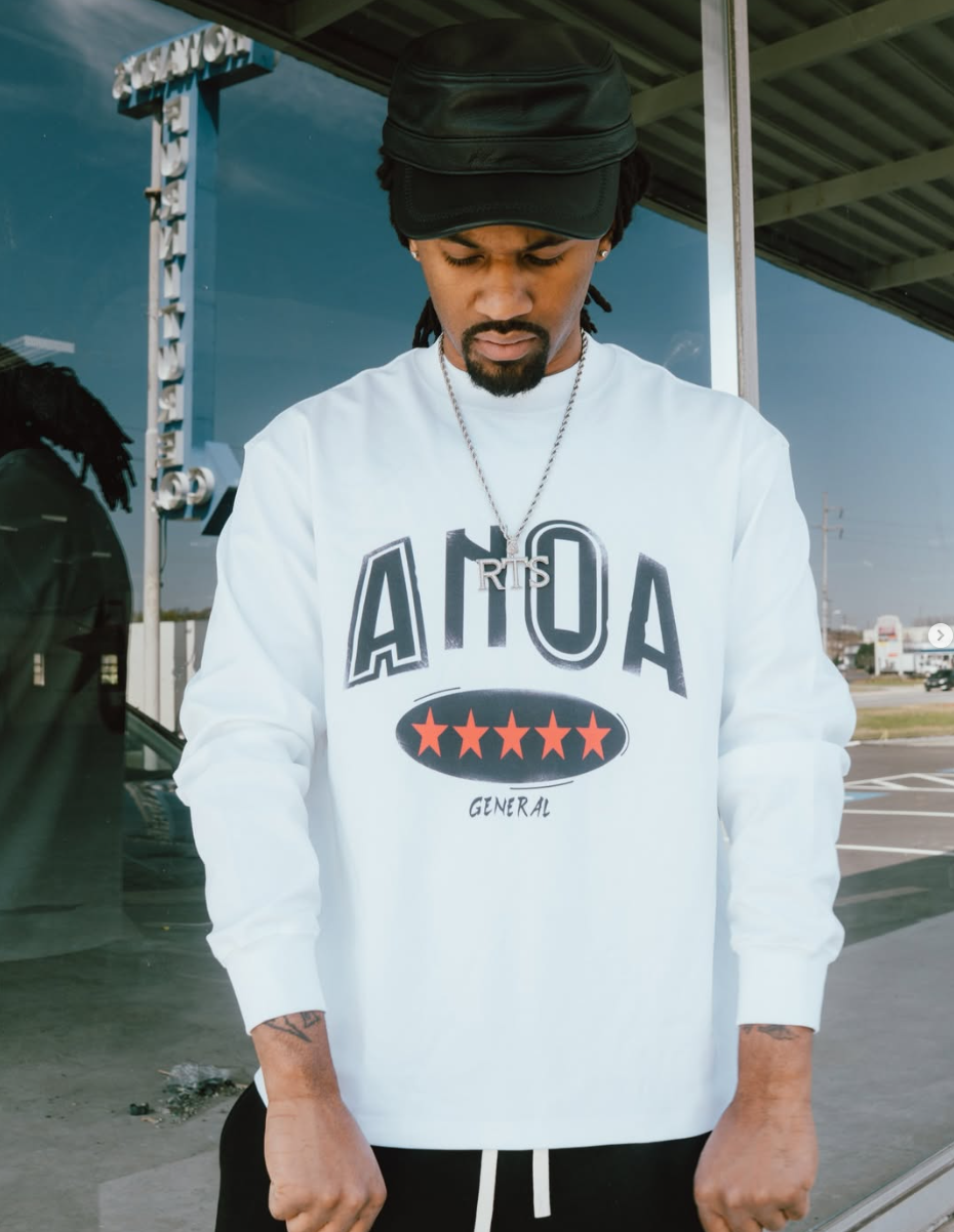 Model wearing white ANOA General graphic sweatshirt